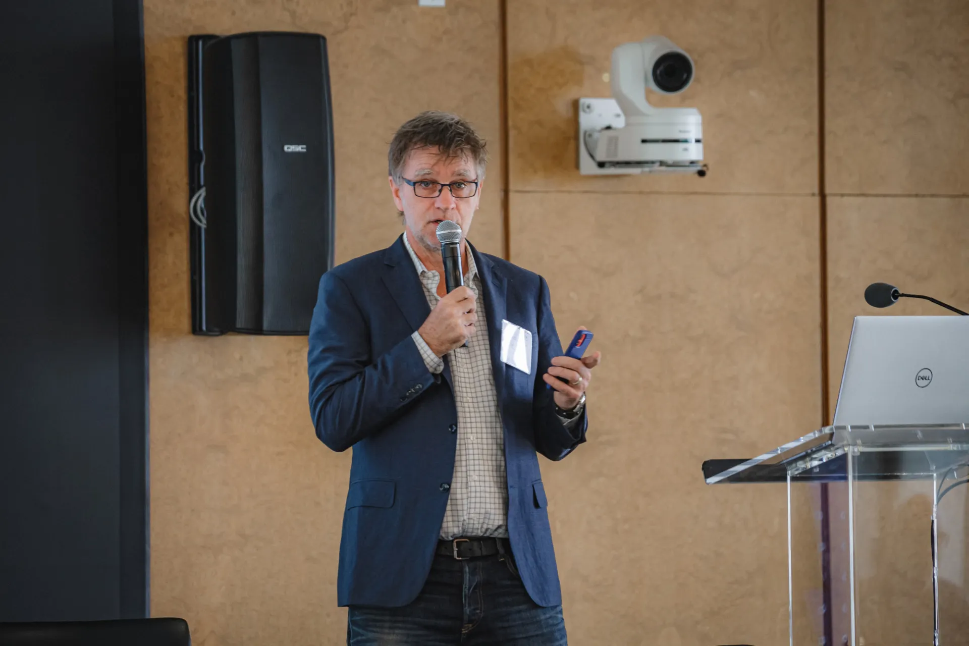 Person talking into a microphone.