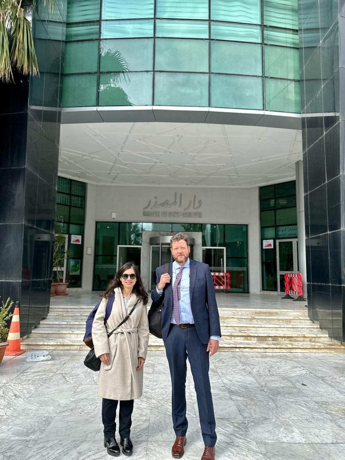 Two people outside a building.